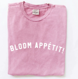 Pink t-shirt with 'BLOOM APPÉTIT!' text on a white background