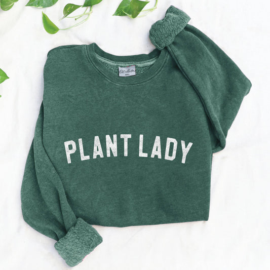 Green sweatshirt with 'PLANT LADY' text on a white background